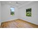 Spacious bedroom with hardwood floors and two windows offering natural light at 1061 Sedeeva St, Clearwater, FL 33755