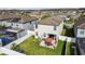 Aerial view of the home's private fenced backyard with patio space, dining furniture, and well-kept lawn at 12408 Victarra Pl, New Port Richey, FL 34655