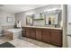 Well-lit bathroom featuring double sinks, granite countertops, and a soaking tub at 12408 Victarra Pl, New Port Richey, FL 34655