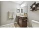 Bathroom featuring a vanity with granite countertop, decorative shelves, and towel rack at 12408 Victarra Pl, New Port Richey, FL 34655