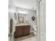 Bathroom featuring vanity with granite countertop, decorative shelves, and tiled floors at 12408 Victarra Pl, New Port Richey, FL 34655