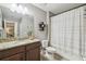 Bathroom featuring a vanity with granite countertop, decorative shelving, and a shower at 12408 Victarra Pl, New Port Richey, FL 34655