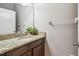 This bathroom features a granite vanity top and a modern sink and faucet at 12408 Victarra Pl, New Port Richey, FL 34655