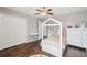 Bedroom featuring a unique bed frame, wood floors, and ample closet space at 12408 Victarra Pl, New Port Richey, FL 34655