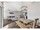 Open dining area showcasing a wood table, bench seating, and a view of the living room at 12408 Victarra Pl, New Port Richey, FL 34655