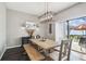 Bright dining room with wooden table, stylish lighting, and sliding glass doors to the patio at 12408 Victarra Pl, New Port Richey, FL 34655