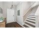 Bright entryway with wood floors, stairs, and a view of the front door at 12408 Victarra Pl, New Port Richey, FL 34655