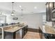 Kitchen view showcasing granite countertops, a breakfast bar, and open layout into the living area at 12408 Victarra Pl, New Port Richey, FL 34655