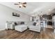 Inviting living room with a large gray sectional sofa and a view into the kitchen at 12408 Victarra Pl, New Port Richey, FL 34655