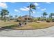 House with a circular driveway and lush green lawn at 1311 Caloosa Lake Ct, Sun City Center, FL 33573