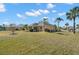 Large backyard with grassy lawn and partial view of home at 1311 Caloosa Lake Ct, Sun City Center, FL 33573