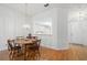 Dining room with hardwood floors and a view of the kitchen at 1311 Caloosa Lake Ct, Sun City Center, FL 33573