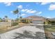 Front view of a single story house with a paved driveway at 1311 Caloosa Lake Ct, Sun City Center, FL 33573