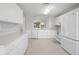 White kitchen with stainless steel appliances and ample counter space at 1311 Caloosa Lake Ct, Sun City Center, FL 33573