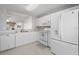 White kitchen with stainless steel appliances and ample counter space at 1311 Caloosa Lake Ct, Sun City Center, FL 33573