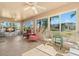 Bright sunroom with tiled floor, comfy seating, and view of backyard at 1311 Caloosa Lake Ct, Sun City Center, FL 33573