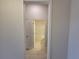 View of bathroom with shower and toilet from hallway at 13154 Kent Bradley St, Dade City, FL 33525