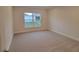 Spacious bedroom with carpeted floor and a window at 13154 Kent Bradley St, Dade City, FL 33525