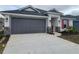 New home exterior features gray siding, red shutters, and stone accents at 13154 Kent Bradley St, Dade City, FL 33525