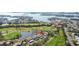 Aerial view showcasing a townhome community near a golf course and body of water at 1326 Pelican Creek Xing # D, Gulfport, FL 33707