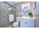 Bathroom featuring a tiled shower with a glass door and a white vanity with a sink at 13908 Orange Dale Pl, Tampa, FL 33625