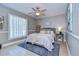 Comfortable bedroom with neutral walls, wood-look floors, and a ceiling fan at 13908 Orange Dale Pl, Tampa, FL 33625