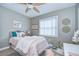 Bright bedroom with a plush bed, window, and fun decor at 13908 Orange Dale Pl, Tampa, FL 33625