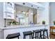 Open-concept kitchen with a breakfast bar, granite countertops, and modern pendant lighting overlooking the dining area at 13908 Orange Dale Pl, Tampa, FL 33625