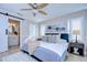 Main bedroom with connecting bath, ceiling fan, and barn-style door at 13908 Orange Dale Pl, Tampa, FL 33625