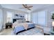 Well-lit main bedroom with a ceiling fan, large windows, and a comfortable bed at 13908 Orange Dale Pl, Tampa, FL 33625