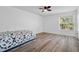 Cozy bedroom with ceiling fan and wood-look flooring at 14003 Fareham Rd, Odessa, FL 33556