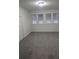 Spacious bedroom with gray carpeting and large windows at 1404 W Granfield Ave, Plant City, FL 33563