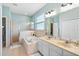 Bright bathroom featuring a double vanity, soaking tub, and glass-enclosed shower with tile surround at 15110 Shearcrest Dr, Lithia, FL 33547