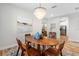 Cozy dining area featuring a wood table, chairs, artwork, and a unique chandelier, enhancing a warm and inviting atmosphere at 15110 Shearcrest Dr, Lithia, FL 33547