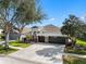 Beautiful home with a three-car garage, stone accents, well-maintained landscaping, and a spacious driveway at 15110 Shearcrest Dr, Lithia, FL 33547