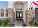 Welcoming front entrance boasting stone pillars and double doors with glass inserts and wreaths at 15110 Shearcrest Dr, Lithia, FL 33547