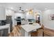 Modern kitchen featuring white cabinetry, a tile backsplash and a quartz breakfast bar with seating at 15110 Shearcrest Dr, Lithia, FL 33547