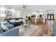 Open-concept living room featuring hardwood floors, ceiling fan, and a view of the kitchen at 15110 Shearcrest Dr, Lithia, FL 33547