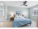 Serene main bedroom features soft blue walls, plush bedding, and a view into the en-suite bathroom, creating a relaxing retreat at 15110 Shearcrest Dr, Lithia, FL 33547