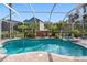 Stunning screened-in pool area featuring lush landscaping and a relaxing spa at 15110 Shearcrest Dr, Lithia, FL 33547