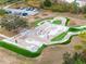 Aerial view of a skate park with ramps, rails, and seating in a park-like community setting at 15110 Shearcrest Dr, Lithia, FL 33547