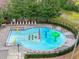 A colorful splash pad area in a fenced-in community featuring several sprayers and lounge chairs at 15110 Shearcrest Dr, Lithia, FL 33547