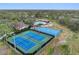 Aerial view of well-maintained tennis and basketball courts in a beautiful community with a pool and clubhouse at 15110 Shearcrest Dr, Lithia, FL 33547