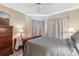 Serene bedroom with gray bedding, dresser, and side table at 1534 Ridge Shore Dr, Tarpon Springs, FL 34689