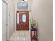 Bright entryway featuring a hardwood floor and a lovely wooden door at 1534 Ridge Shore Dr, Tarpon Springs, FL 34689