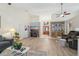 Spacious living room featuring hardwood floors, a large sectional sofa, and a fireplace at 1534 Ridge Shore Dr, Tarpon Springs, FL 34689