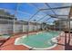 Inviting kidney-shaped swimming pool with screened enclosure at 1534 Ridge Shore Dr, Tarpon Springs, FL 34689