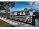 Backyard view of home with a newly stained deck, perfect for outdoor entertaining and relaxing at 1570 S Michigan Ave, Clearwater, FL 33756