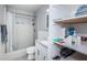 Bathroom featuring shower and tub combination, single granite vanity, and modern white shelving at 1570 S Michigan Ave, Clearwater, FL 33756