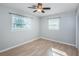 Bedroom with neutral walls, vinyl floor, and two windows with white blinds at 1570 S Michigan Ave, Clearwater, FL 33756